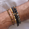 Men's Tiger's Eye Bracelet w 14k Gold Bead stacked with the Yellow Agate bracelet w 2 14k gold beads, a Black Onyx bracelet w 14k gold bead and our Natural Fossil bracelet for men