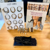 Jewelry display with 'Lizzy James' branding on a wooden table.