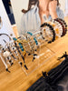 Bracelets on a clear stand with a person in the background