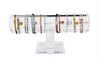 Collection of bracelets on a clear acrylic stand against a wooden background