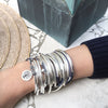 April 2 strand wrap bracelet in natural true blue leather, comes as shown with Tree of Life charm attached. Shown here with the Lizzy Too 5 Strand in Blueberry, sold separately.