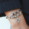 Faith bracelet in black leather, cross charm comes as shown