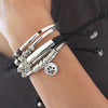 Faith bracelet stacked next to the Wish and Calm Bracelets in Natural Black leather, each sold separately
