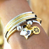 Round Paw Charm Gold shown with the Girlfriend Wrap with 2 Heart Charms in Silver & Gold (sold separately)