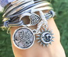 Stamped Tree of Life pendant in silver shown next to moon sun charm (sold separately)